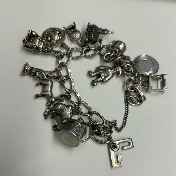Vintage instantly heavy sterling silver travel charms...